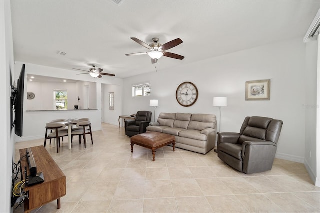 tiled living room featuring ceiling fan