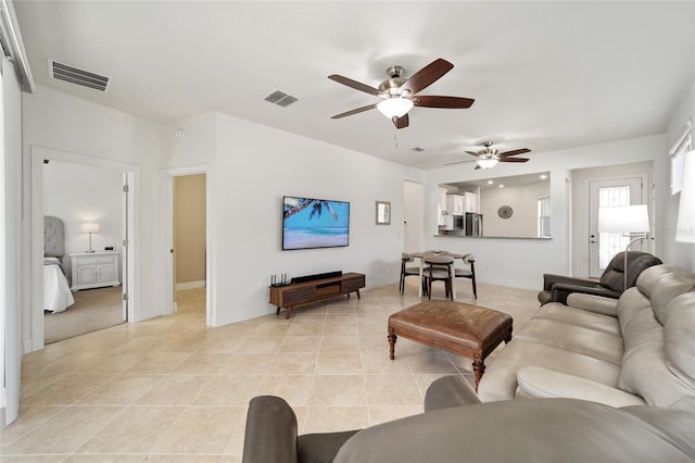 tiled living room with ceiling fan