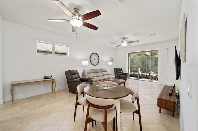 tiled dining room with ceiling fan