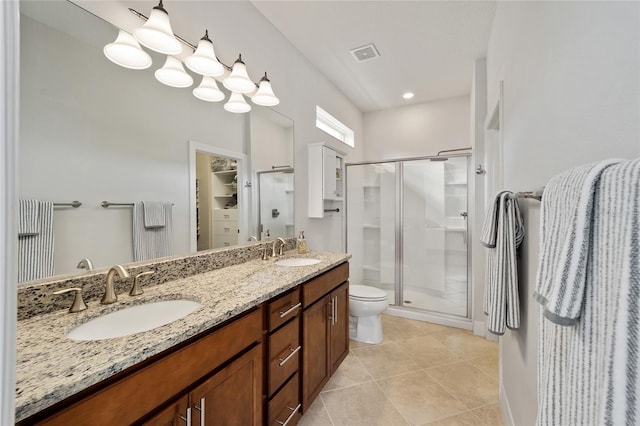 bathroom with tile patterned flooring, vanity, toilet, and an enclosed shower