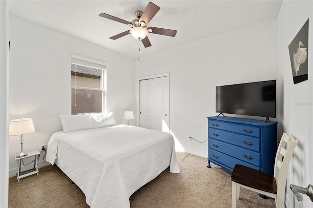 carpeted bedroom with a closet and ceiling fan