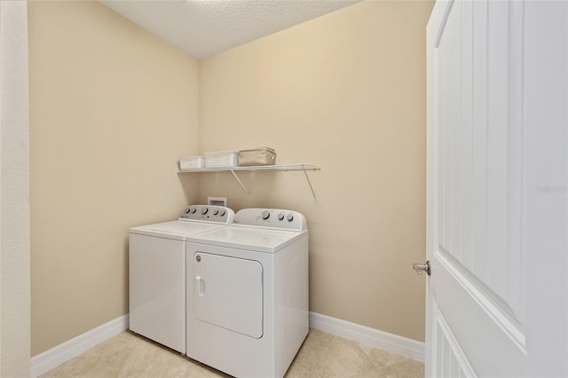 laundry area featuring light tile patterned floors, a textured ceiling, and independent washer and dryer