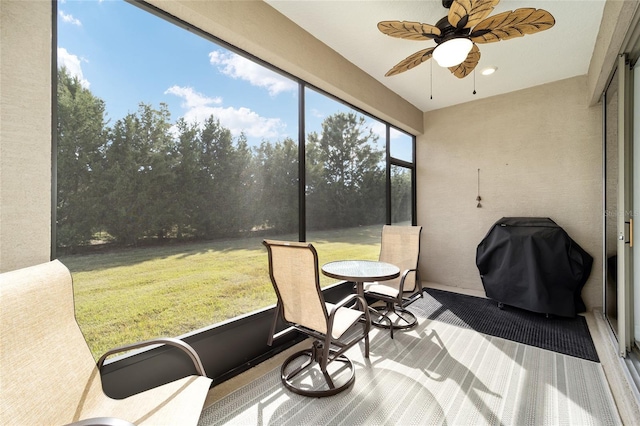 sunroom featuring ceiling fan