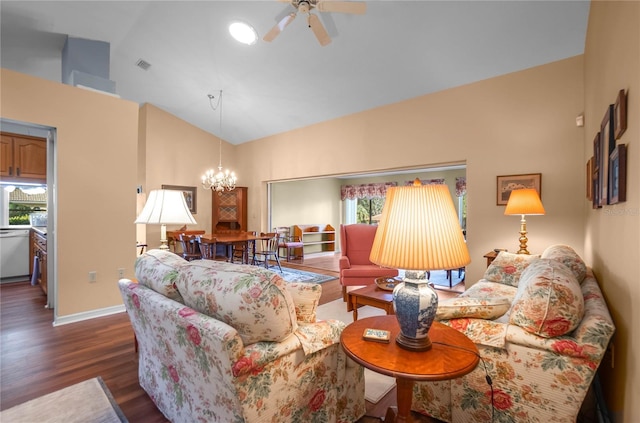 living room featuring dark hardwood / wood-style flooring, high vaulted ceiling, and ceiling fan with notable chandelier