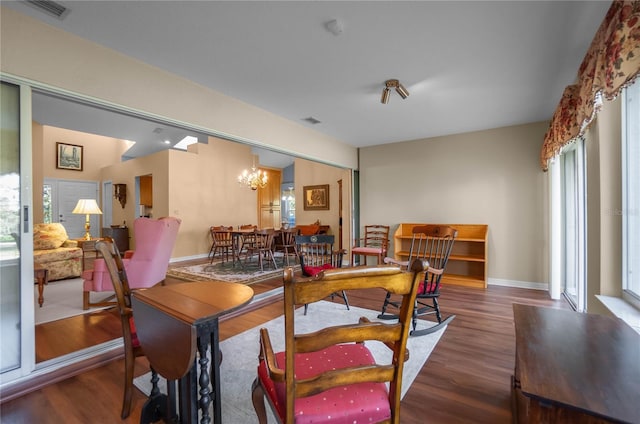 dining space featuring a chandelier and dark hardwood / wood-style flooring