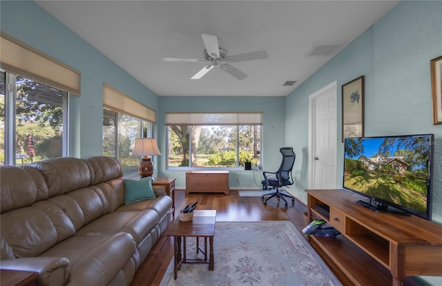 living room with ceiling fan and light wood-type flooring