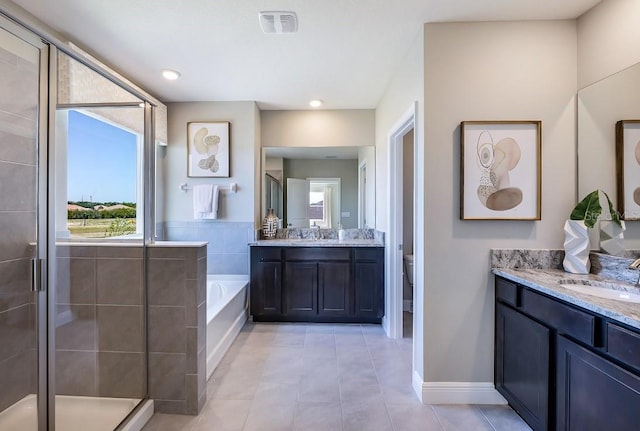 full bathroom with tile patterned floors, vanity, independent shower and bath, and toilet