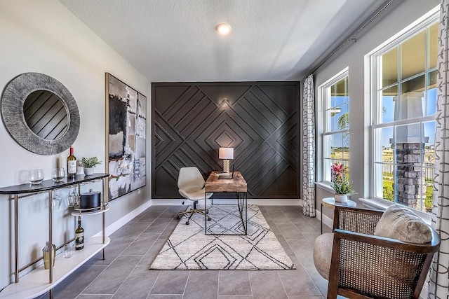 office space featuring bar area and a textured ceiling