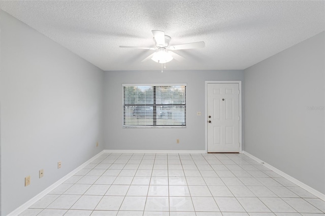 tiled spare room featuring ceiling fan and a textured ceiling