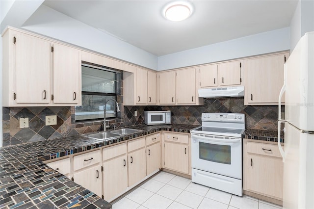 kitchen with tasteful backsplash, white appliances, sink, light brown cabinets, and light tile patterned floors