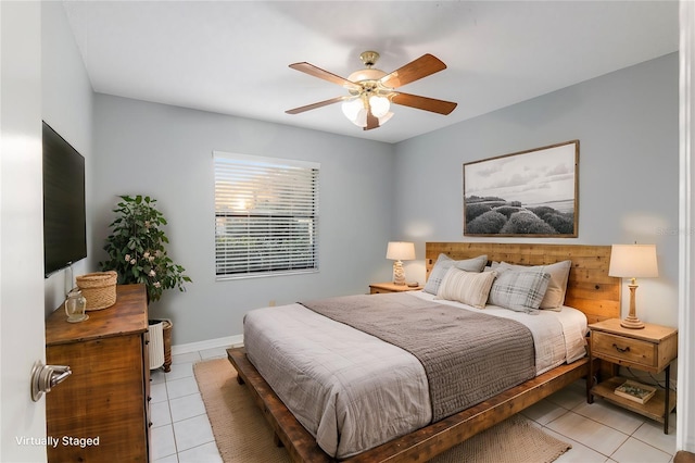 tiled bedroom featuring ceiling fan