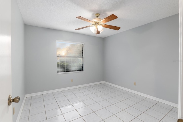 empty room with light tile patterned floors, a textured ceiling, and ceiling fan