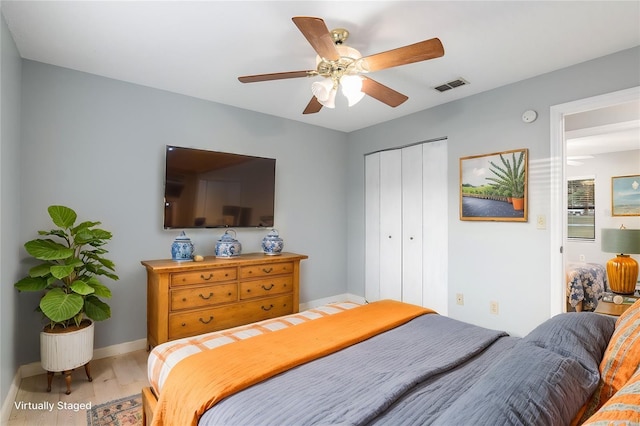 bedroom featuring hardwood / wood-style flooring, ceiling fan, and a closet