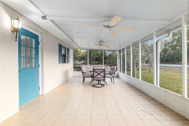 unfurnished sunroom featuring ceiling fan