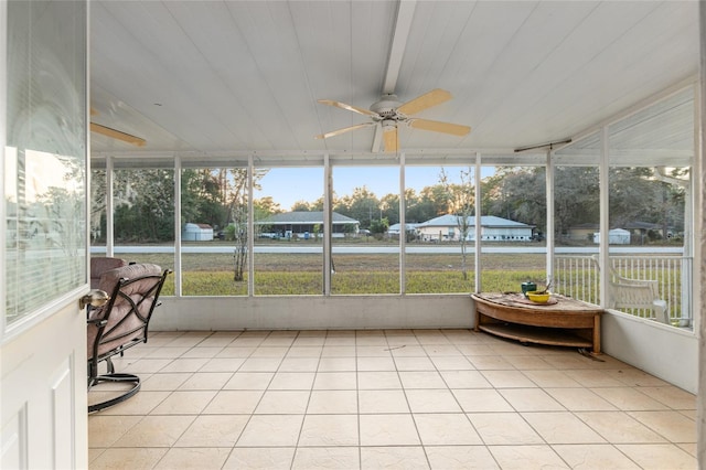 unfurnished sunroom featuring ceiling fan