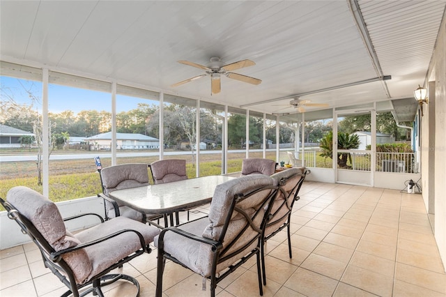 sunroom / solarium featuring ceiling fan