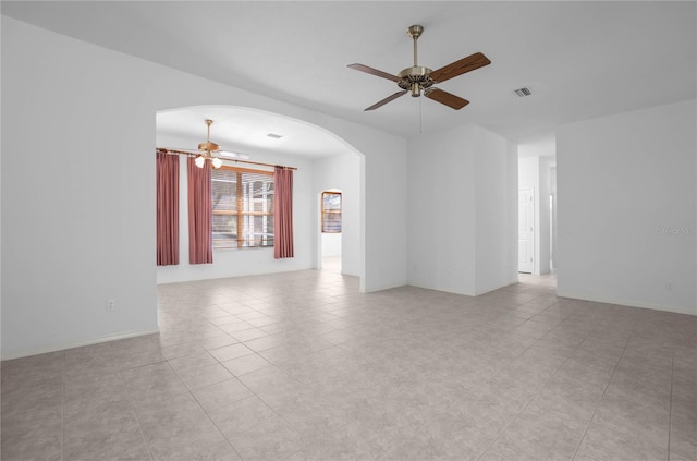 tiled spare room featuring ceiling fan