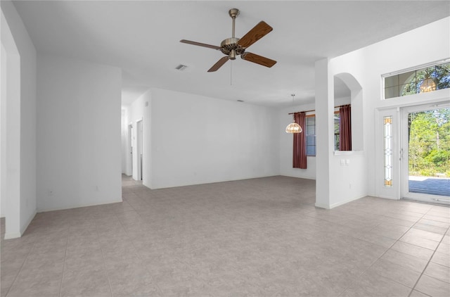 unfurnished living room with ceiling fan and light tile patterned floors