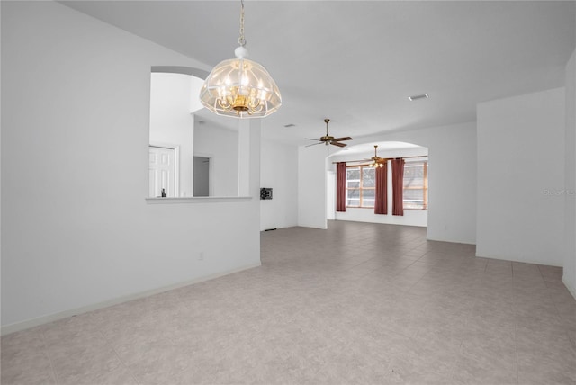 tiled empty room featuring ceiling fan with notable chandelier