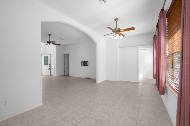 empty room featuring light tile patterned floors and ceiling fan