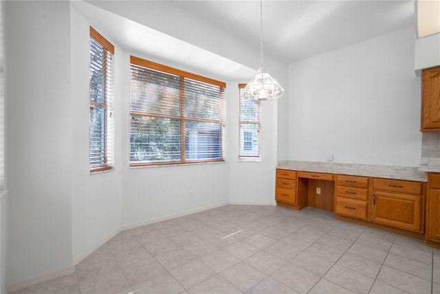 kitchen featuring light tile patterned floors, decorative light fixtures, and a wealth of natural light