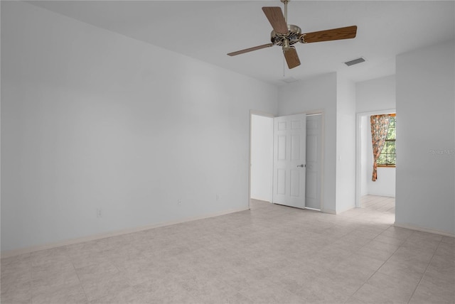 empty room featuring light tile patterned floors and ceiling fan