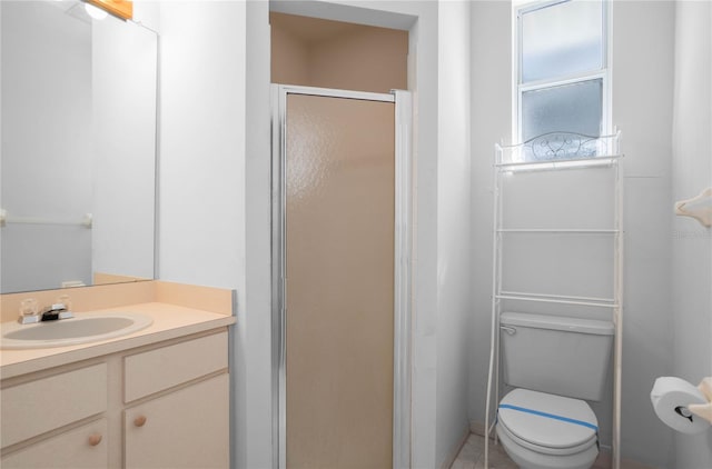 bathroom with vanity, toilet, and walk in shower