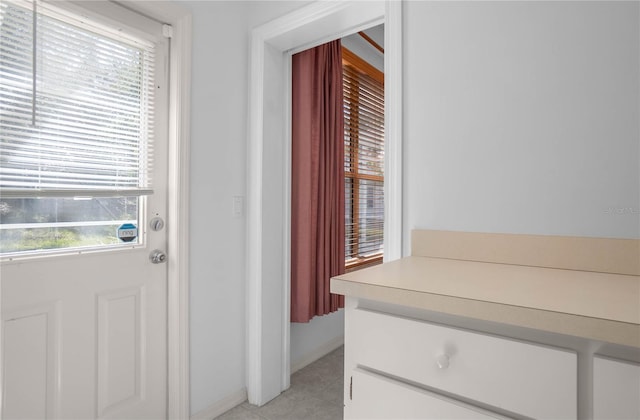 entryway with light tile patterned flooring and a healthy amount of sunlight