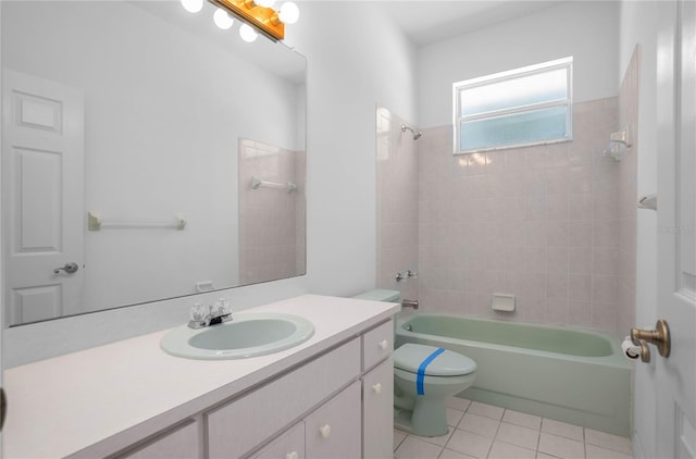 full bathroom featuring tile patterned floors, tiled shower / bath combo, toilet, and vanity