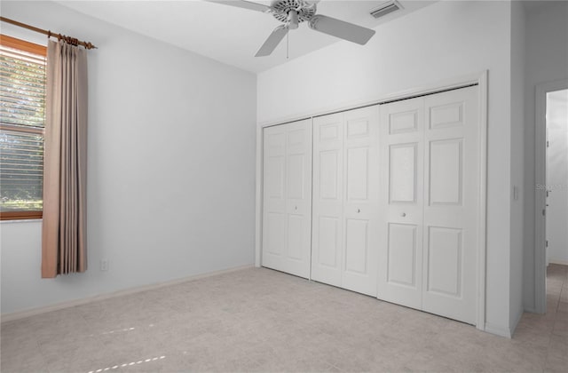 unfurnished bedroom featuring a closet, multiple windows, and ceiling fan