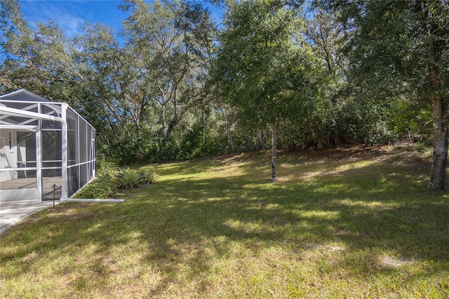 view of yard featuring glass enclosure