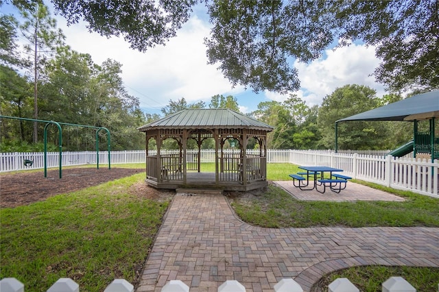 view of property's community with a gazebo, a playground, and a lawn