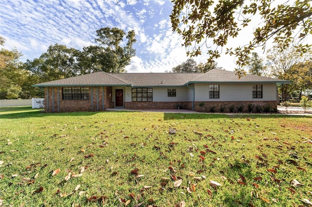 ranch-style house with fence, a front lawn, and brick siding