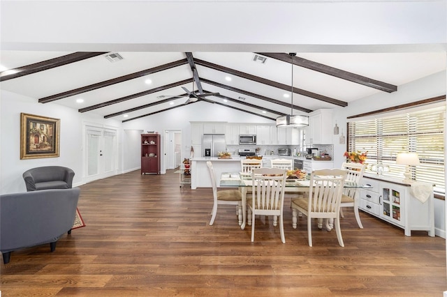 dining room featuring vaulted ceiling with beams and dark wood-type flooring