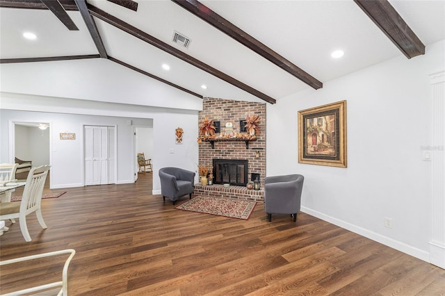 living room featuring vaulted ceiling with beams, a fireplace, and dark hardwood / wood-style floors