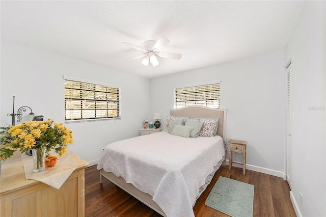 bedroom featuring ceiling fan, dark hardwood / wood-style flooring, and a closet