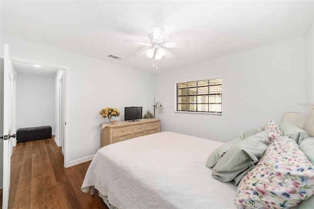 bedroom featuring ceiling fan and dark wood-type flooring