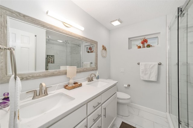 bathroom with vanity, a textured ceiling, toilet, and walk in shower