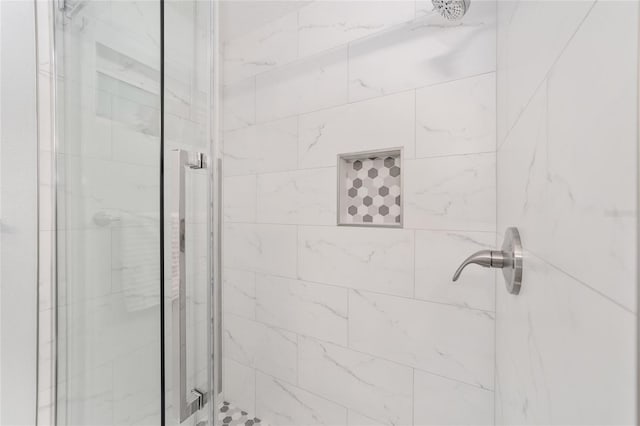 bathroom with a shower with door