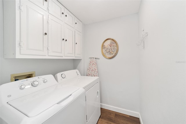 clothes washing area featuring cabinets, independent washer and dryer, and dark hardwood / wood-style flooring