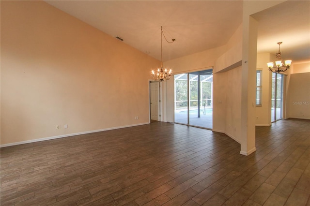 empty room featuring a chandelier and dark wood-type flooring