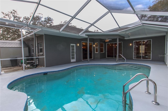 view of swimming pool with a patio and a lanai