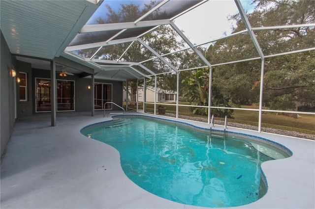 view of swimming pool featuring a lanai and a patio