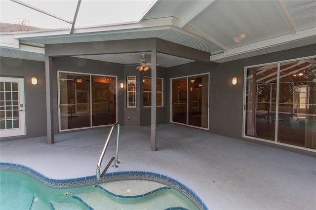 view of swimming pool with a lanai, ceiling fan, and a patio area