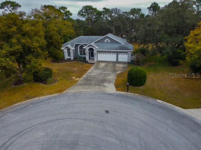 view of front of home with a front yard and a garage