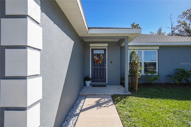 entrance to property with a yard