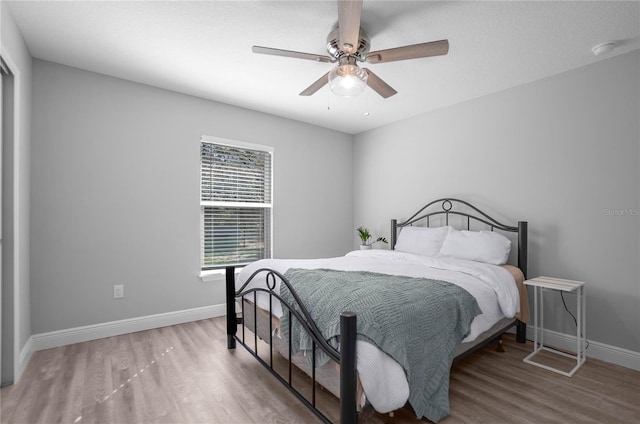 bedroom featuring hardwood / wood-style flooring and ceiling fan