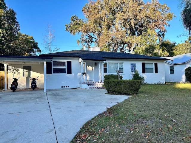 single story home featuring a front lawn and a carport