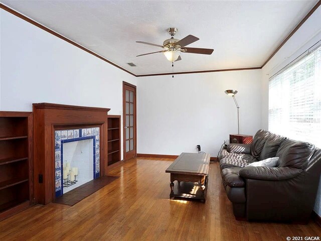 living room featuring french doors, dark hardwood / wood-style flooring, ceiling fan, and crown molding