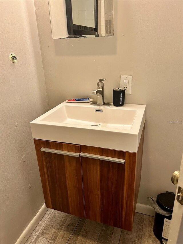 bathroom with hardwood / wood-style floors and vanity